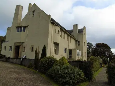 a large white building with towers on top of it at Snug - Meadhan Apartment in Helensburgh