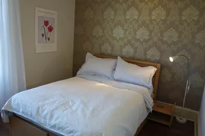 a bedroom with a bed with white sheets and pillows at Sophisticated Edinburgh Apartment in City Centre in Edinburgh