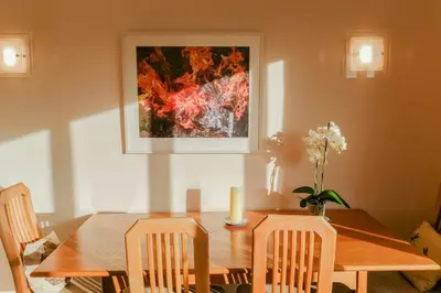 a dining room table with a candle and a painting at Sophisticated Edinburgh Apartment in City Centre in Edinburgh