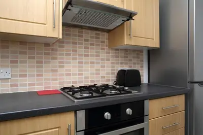 a kitchen with a black stove top oven at Stylish 2 Bedroom Bruntsfield Apartment in Edinburgh in Edinburgh