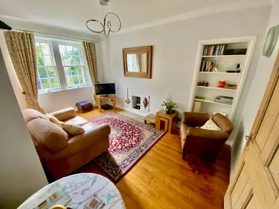 a living room with a couch and two chairs at Underneath the Arches in Penicuik