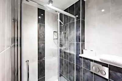 a black and white bathroom with a shower at Glasgow City Flats in Glasgow