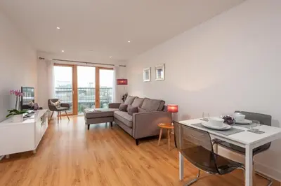 a living room with a couch and a table at Glasgow City Flats in Glasgow