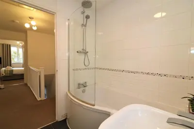 a bathroom with a tub and a sink and a shower at Signature - Angus House Glasgow in Glasgow