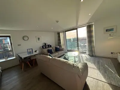 a living room with a couch and a table at Principal Apartments - Clyde Waterfront Apartments in Glasgow