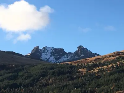 a mountain range with trees and snow capped mountains at TwoStones in Arrochar
