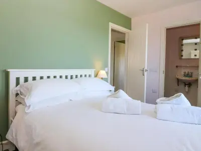 a bedroom with two beds with white pillows at Driftwood Cottage in Craignure