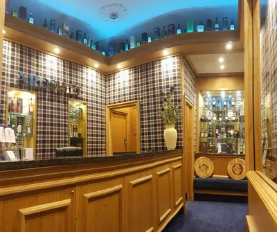 a bar in a restaurant with a blue ceiling at Ardshiel Hotel in Campbeltown
