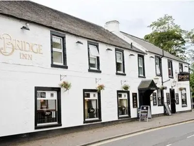 a white building on the side of a street at The Bridge Inn in Tillicoultry