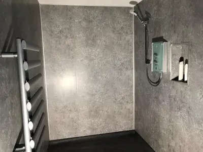 a shower in a bathroom with a wall at Finlaystone Family Barn in Port Glasgow