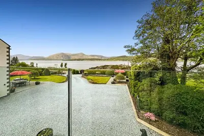 a view of the water from the balcony of a house at Skyfall Glencoe at Creag ant Sionnaich Glencoe Ballachulish Highlands Near Fortwilliam in Glencoe