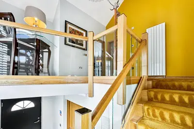 a staircase in a house with yellow walls at Skyfall Glencoe at Creag ant Sionnaich Glencoe Ballachulish Highlands Near Fortwilliam in Glencoe