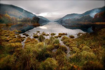 a view of a lake in the middle of a valley at Monachyle Mhor Hotel in Lochearnhead