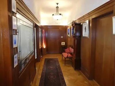 a hallway with wood paneling and a chair and a table at The Cairn Residence in Edinburgh