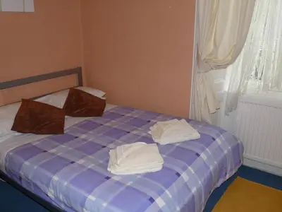 a bedroom with a bed with towels on it at Arbour Guest House in Oban
