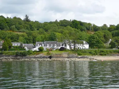 a house on the shore of a body of water at The Creggans Inn in Strachur