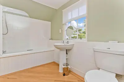 a white bathroom with a sink and a toilet at The Creggans Inn in Strachur