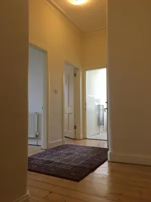 an empty room with a rug on a wooden floor at Menzies Apartments in Edinburgh