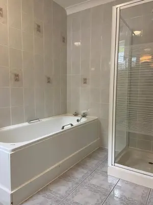 a white bath tub in a bathroom with a shower at The Lagg in Lagg