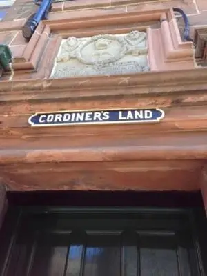 a sign over the door of a building at The cosy courtyard in Edinburgh
