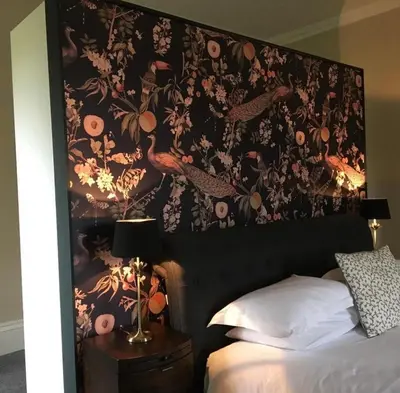 a bedroom with a large floral patterned wall above a bed at Leirsinn Mhor in Killin
