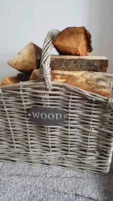 a basket filled with bread and wood on a table at The Old School in Salen