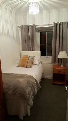 a bedroom with a bed and a window at The Old School in Salen