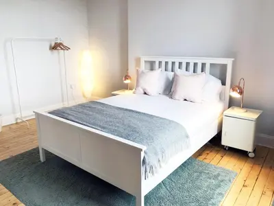 a bedroom with a white bed with white pillows at Stylish City Centre Apartments - D Terrace Residence in Edinburgh
