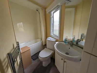 a bathroom with a toilet and a sink at The Senator 69 in Dunoon
