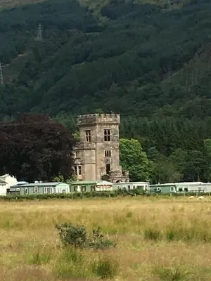 an old building with a train in a field at The Senator 69 in Dunoon