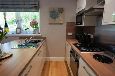 a kitchen with a stove and a counter top at Riverbank in Callander