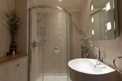 a bathroom with a shower and a sink and a shower at Mains of Taymouth Country Estate 4* Houses in Kenmore
