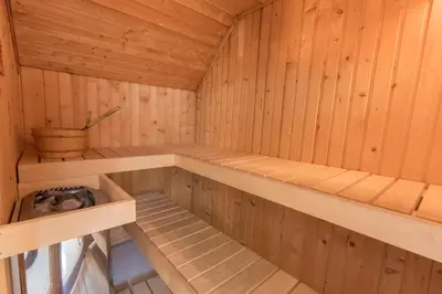 a sauna with wooden walls and wooden shelves at Mains of Taymouth Country Estate 5* Houses in Kenmore