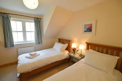 a bedroom with two beds and a window at Feochan Bheag in Oban
