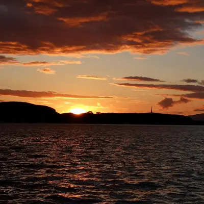 a sunset over a large body of water at Feochan Bheag in Oban
