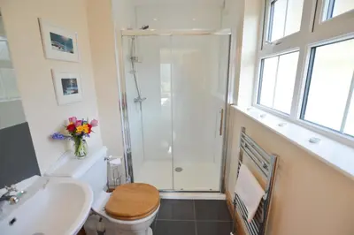a bathroom with a shower and a toilet and a sink at Feochan Bheag in Oban