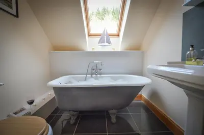 a bathroom with a bath tub and a sink at Feochan Bheag in Oban