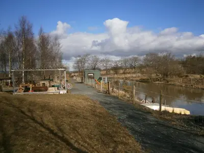 a path next to a river with a fence at Fairview Bed and Breakfast in Airdrie