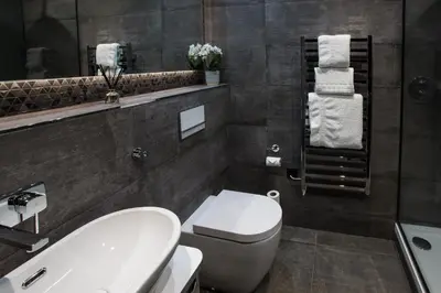 a bathroom with a white toilet and a sink at Mondo Hotel in Coatbridge