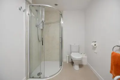 a bathroom with a shower and a toilet at Pottery Cottage, Lochans Lodge in Stranraer