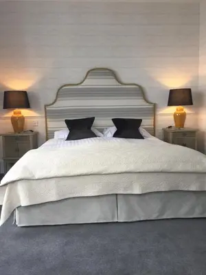 a bedroom with a white bed with two lamps at Glenburnie House in Oban