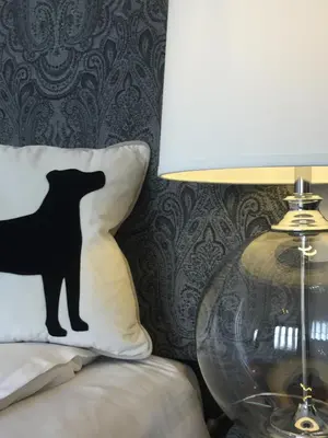 a black cat stencil on a pillow next to a lamp at Glenburnie House in Oban