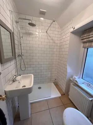a bathroom with a sink and a shower at The Cottage in Dunblane