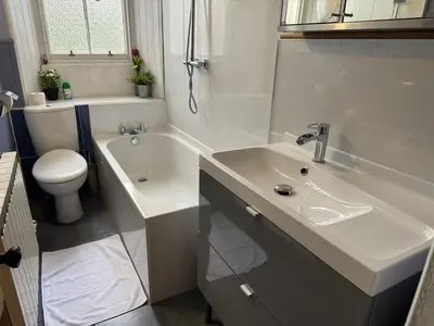 a bathroom with a sink and a tub and a toilet at Classic Edinburgh Flat in the heart of Morningside in Edinburgh