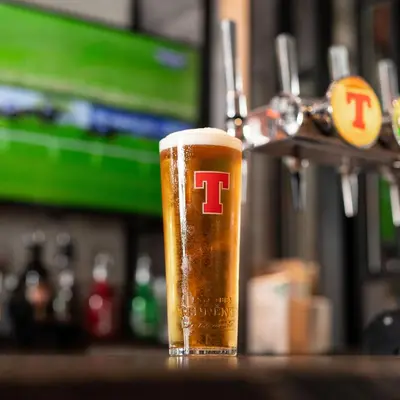 a glass of beer with the t on it at Royal Hotel in Cumnock