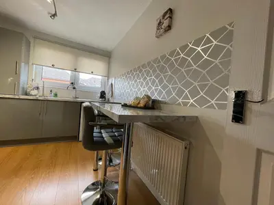 a kitchen with a counter and a counter top at HLA - KING COURT APARTMENT 2 in Motherwell