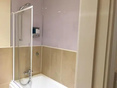 a shower with a glass door in a bathroom at Marina View Apartment in Inverkip