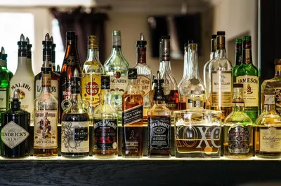 a bunch of bottles of alcohol on a bar at The Popinjay Hotel in Larkhall