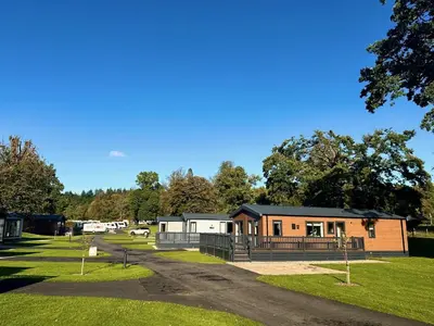 a small cabin in a park with a driveway at Callander Woods Holiday Park in Callander