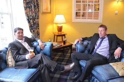 two men sitting in chairs in a hotel room at Creebridge House Hotel in Newton Stewart
